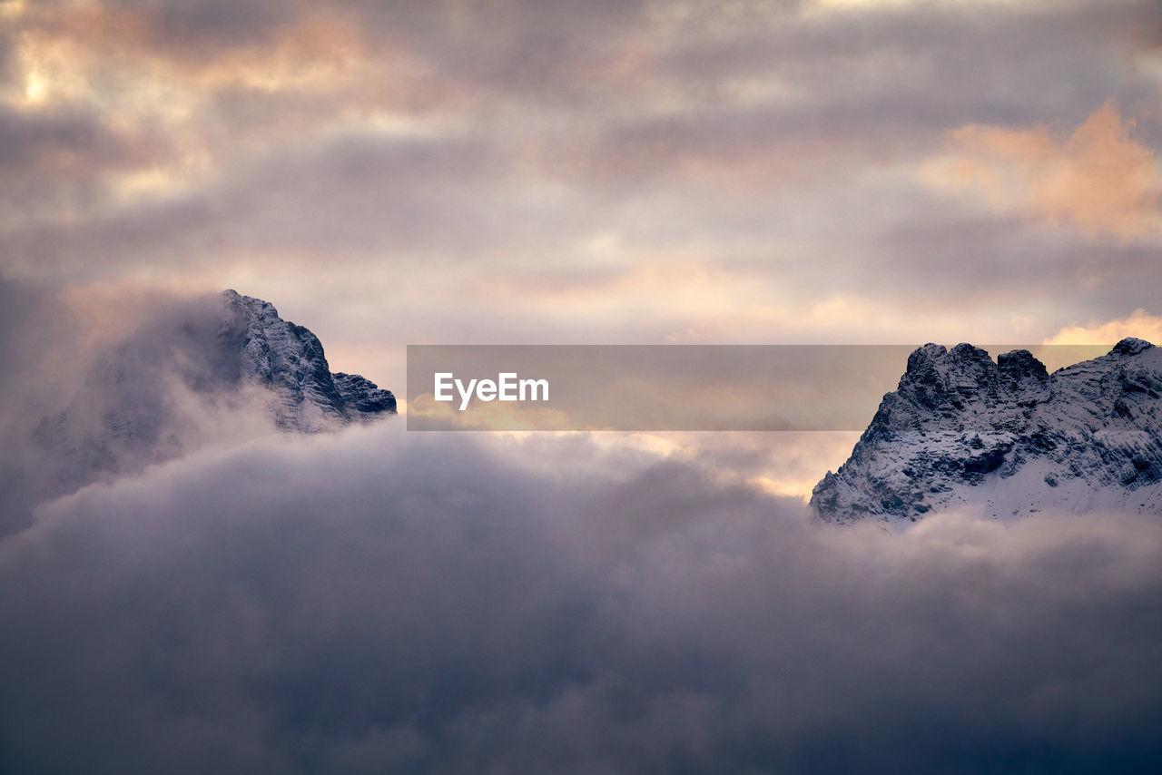 LOW ANGLE VIEW OF SNOWCAPPED MOUNTAINS AGAINST SKY