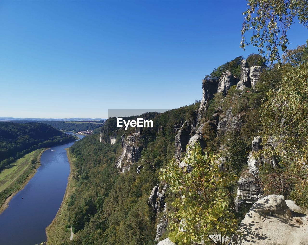 Scenic view of mountains against clear blue sky