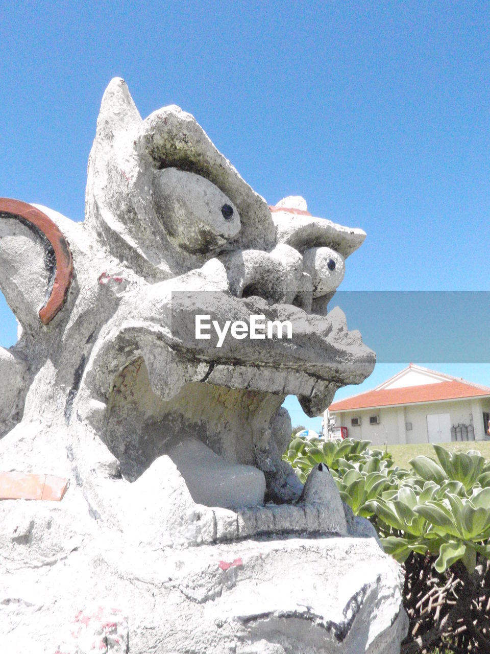 Low angle view of statue against blue sky