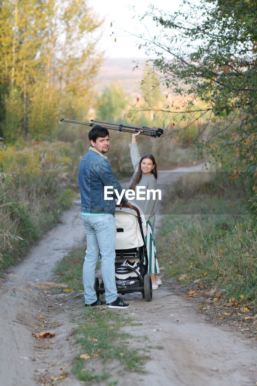 Rear view of couple walking on road