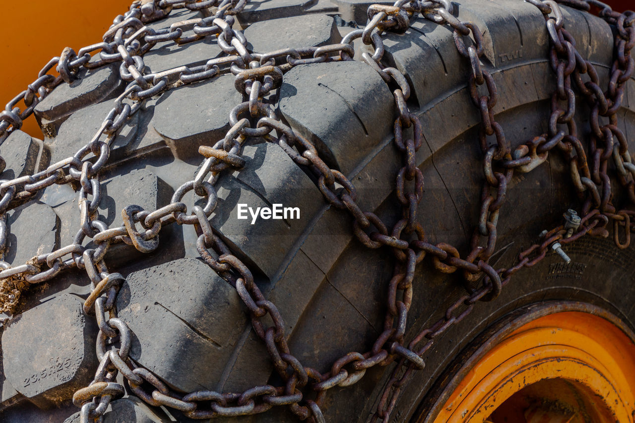 no people, tire, day, mode of transportation, transportation, close-up, vehicle, metal, chain, rope, outdoors