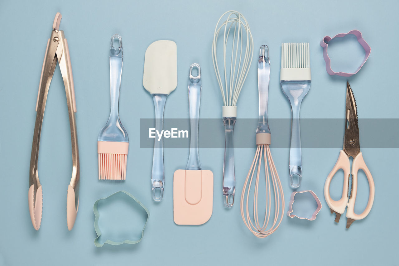 Directly above shot of kitchen utensils against blue background