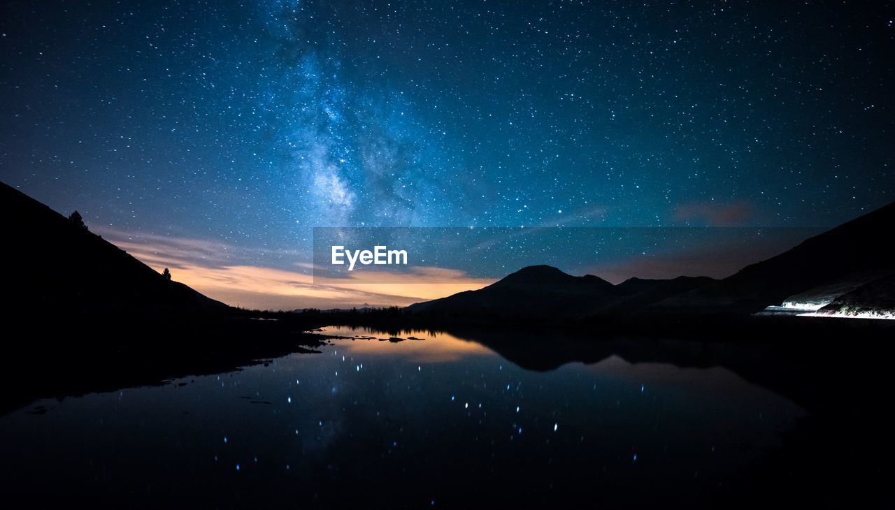 Scenic view of lake against star field