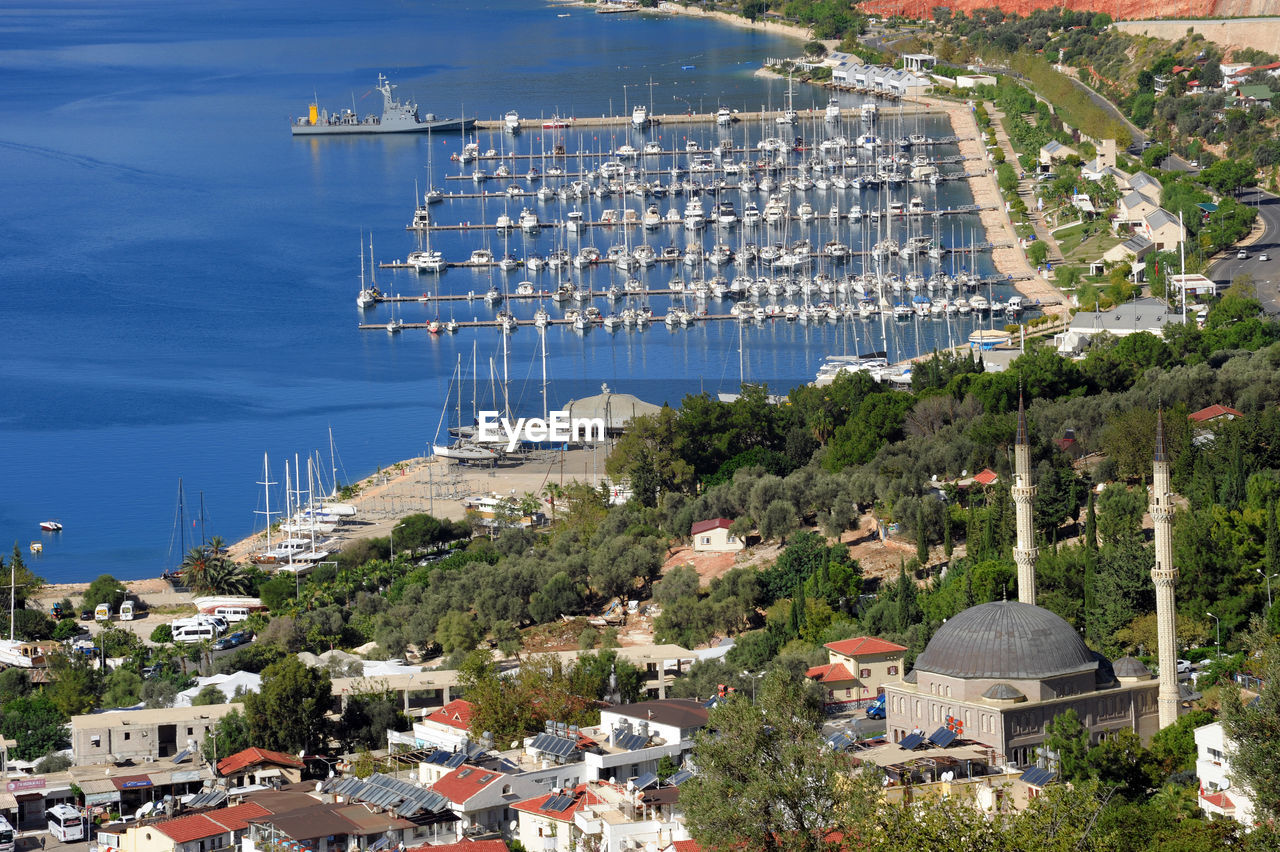 High angle view of townscape by sea against sky