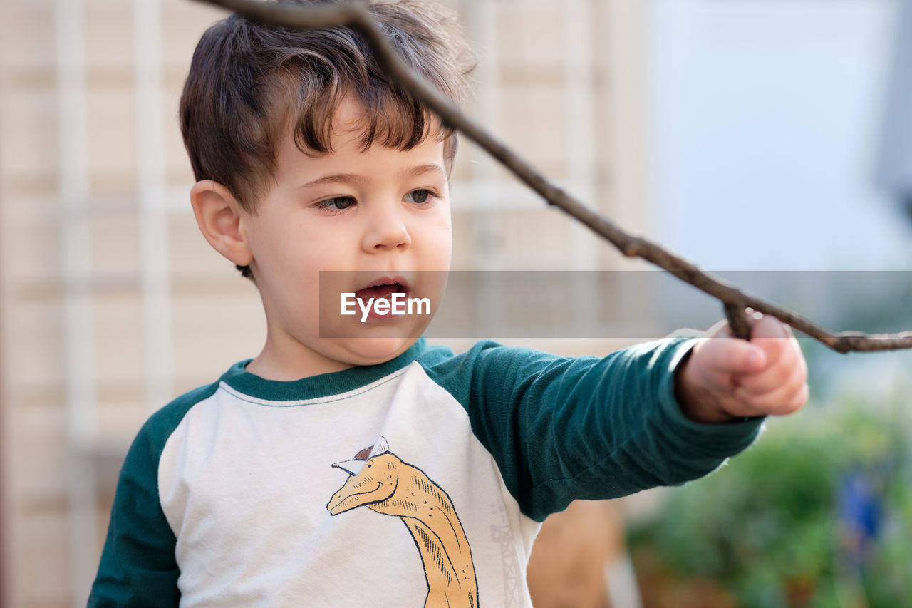 Cute little boy playing in the backyard