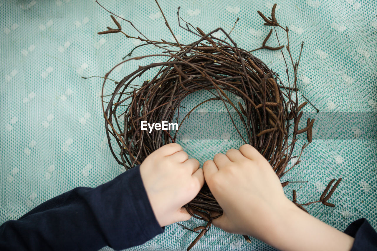 Children make a wreath of branches, nest for birds