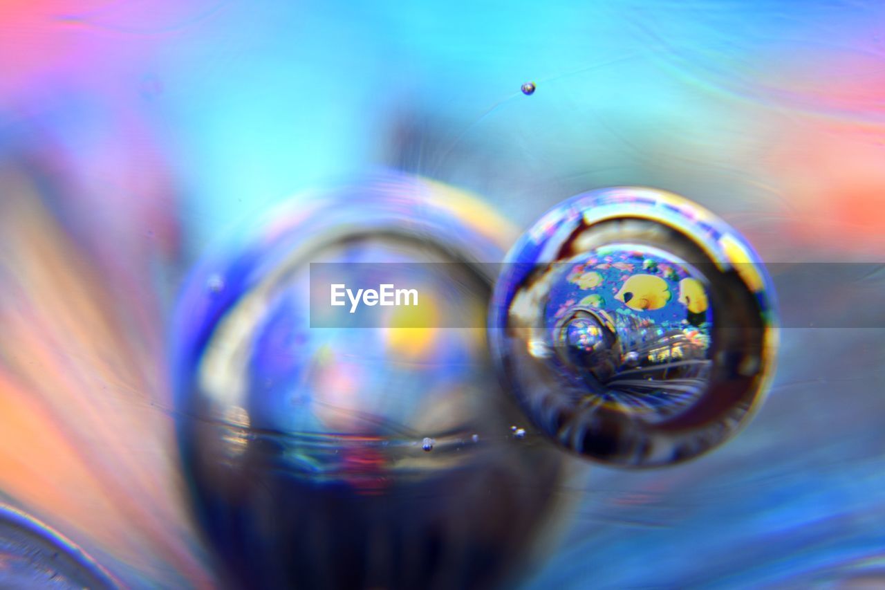 CLOSE-UP OF WATER DROP ON ABSTRACT BACKGROUND