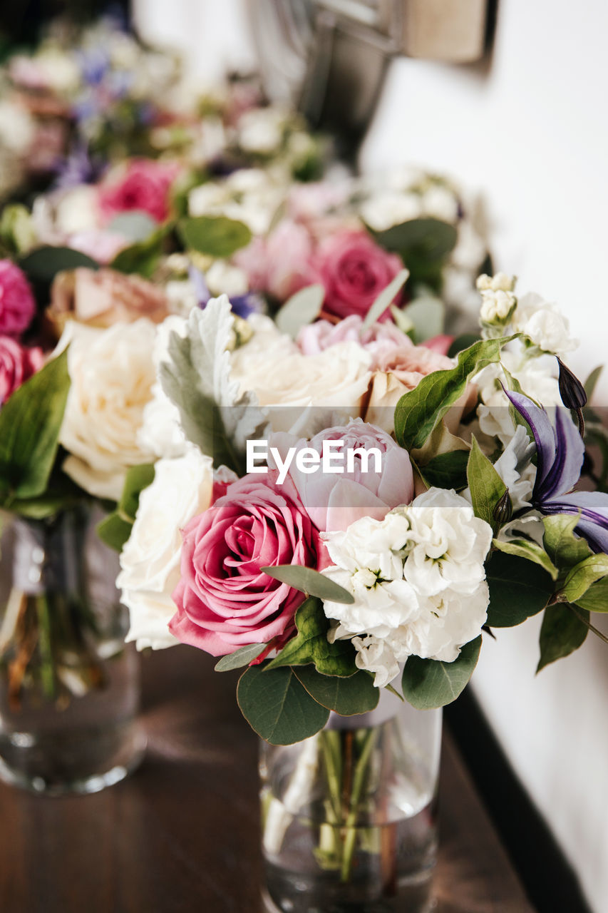 Close up of bridal wedding bouquet - pink peonies, rabbit ear plant, white hydrangea, purple lilies.