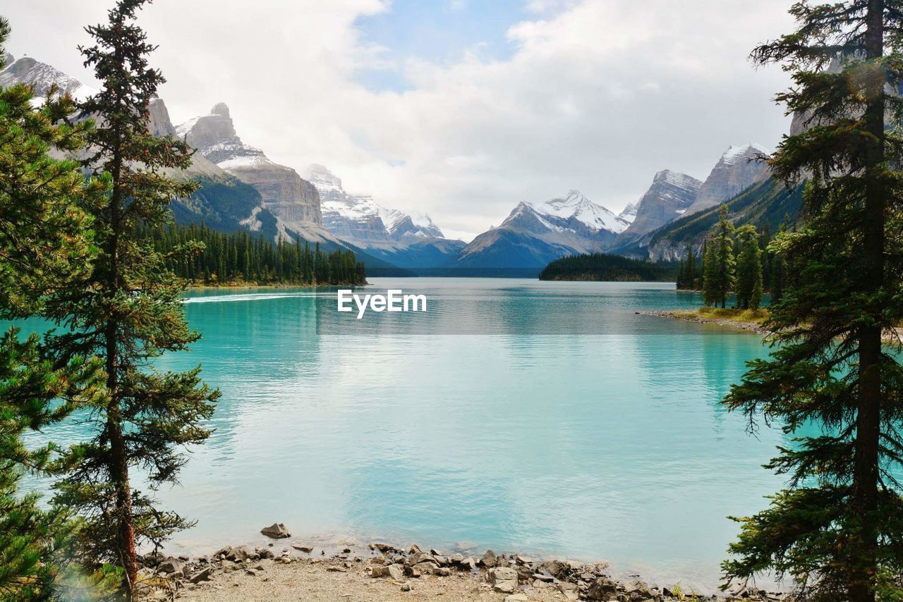 Scenic view of lake and mountains against sky