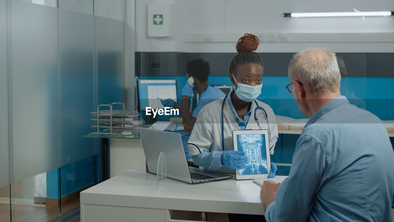 People working on table in office