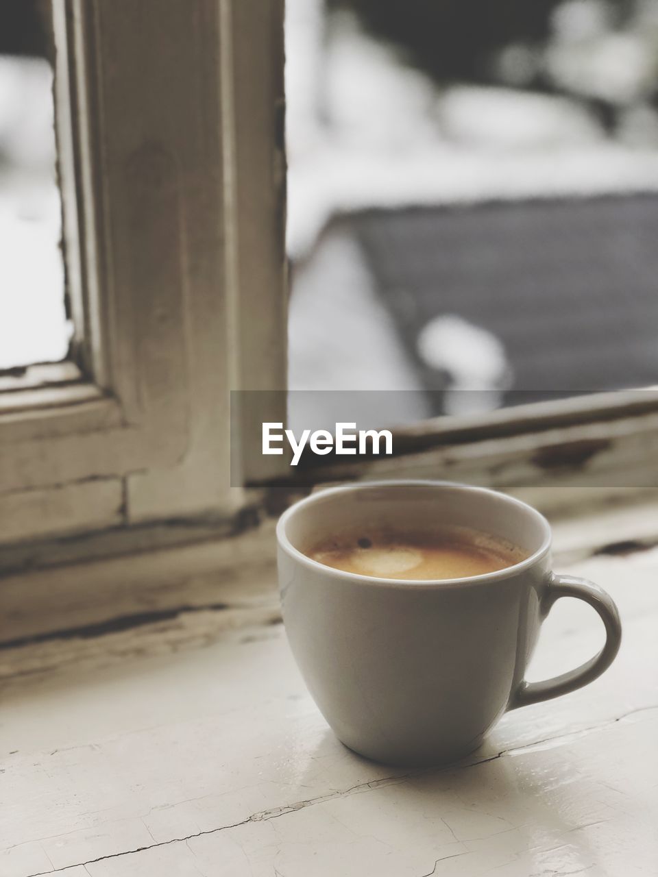 Close-up of coffee on window sill