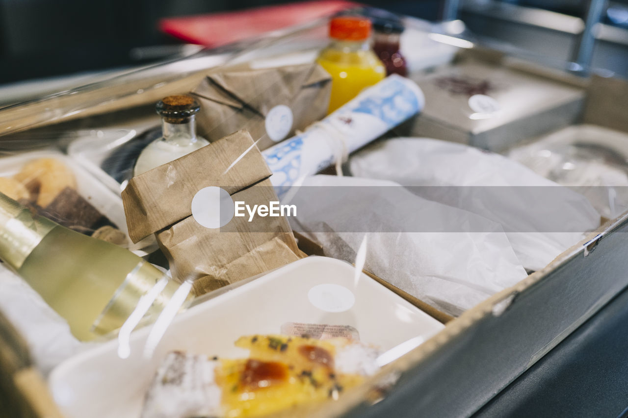 Close-up of food packages in cardboard box at restaurant