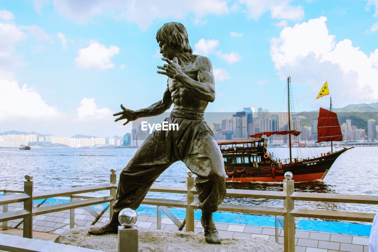 REAR VIEW OF STATUE AGAINST SEA AND SKY