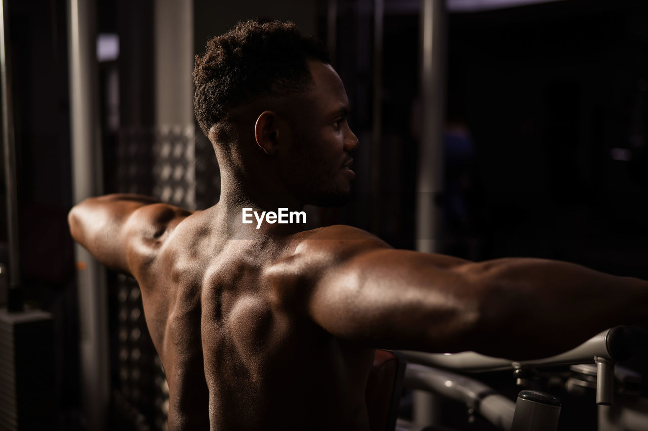 side view of woman exercising in gym