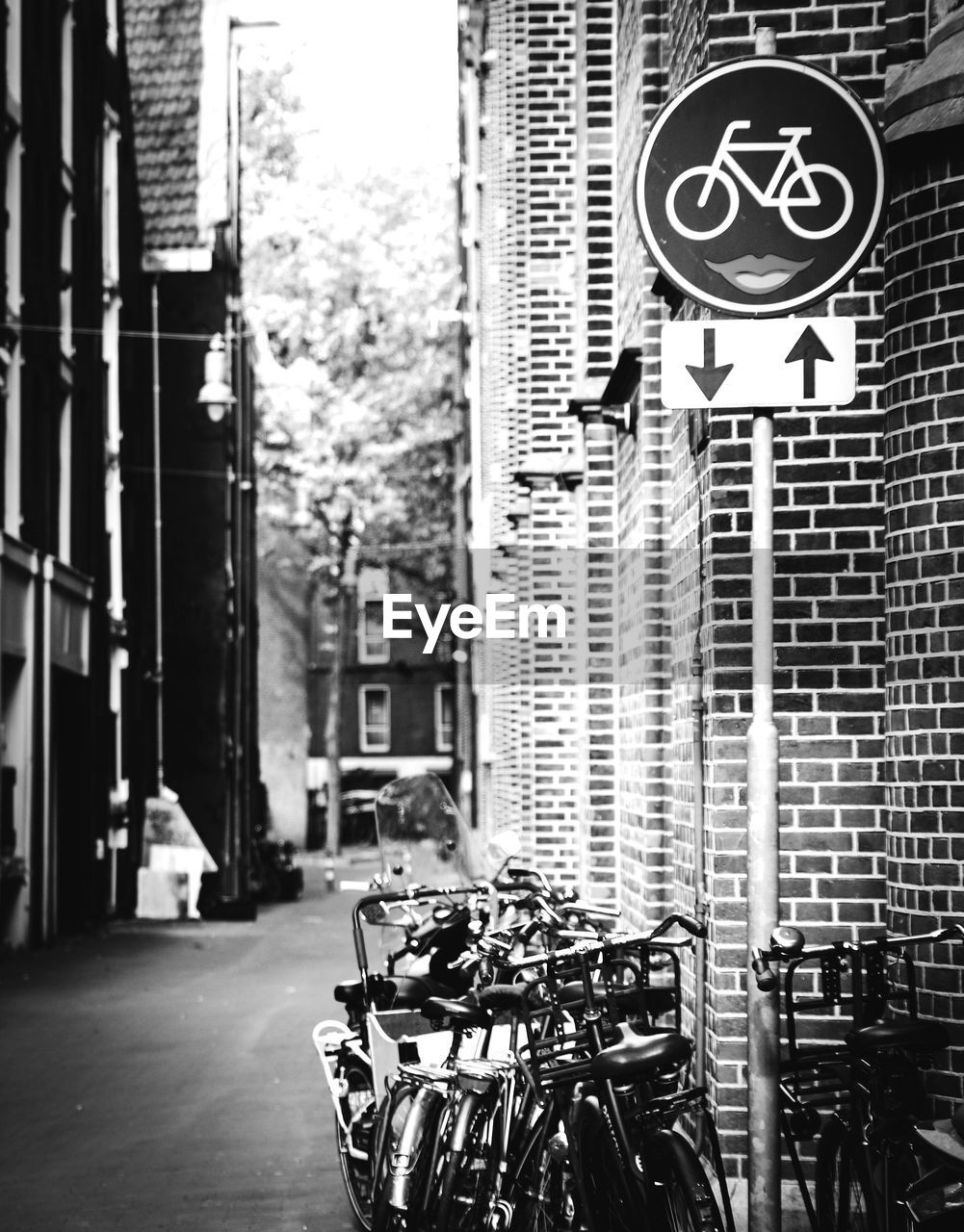 Bicycles parked on street amidst buildings