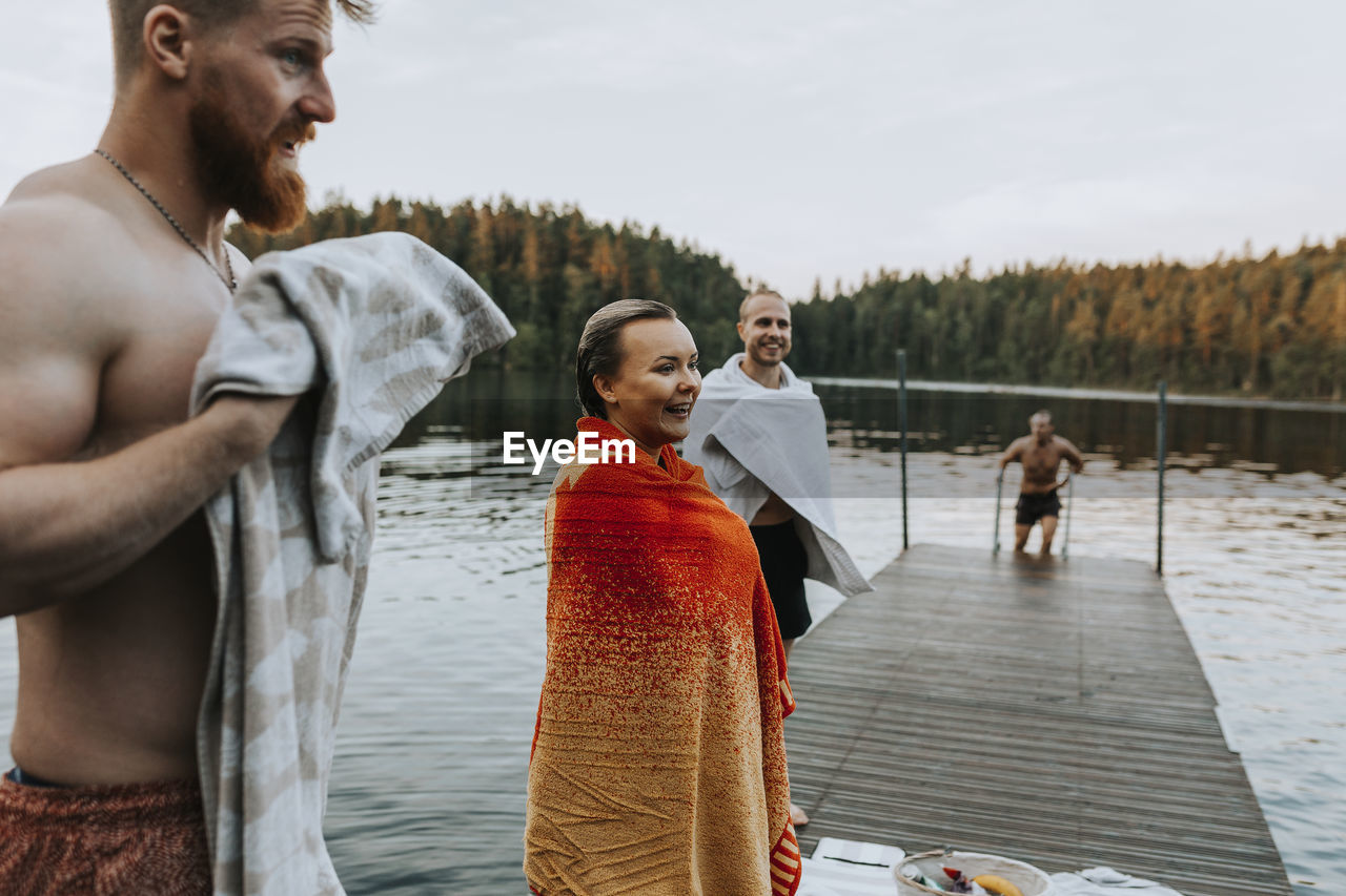 Smiling friends at lake