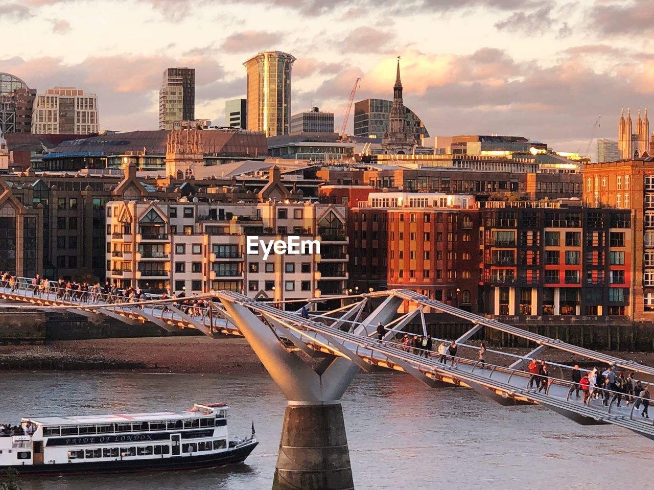 Bridge over river against buildings in city