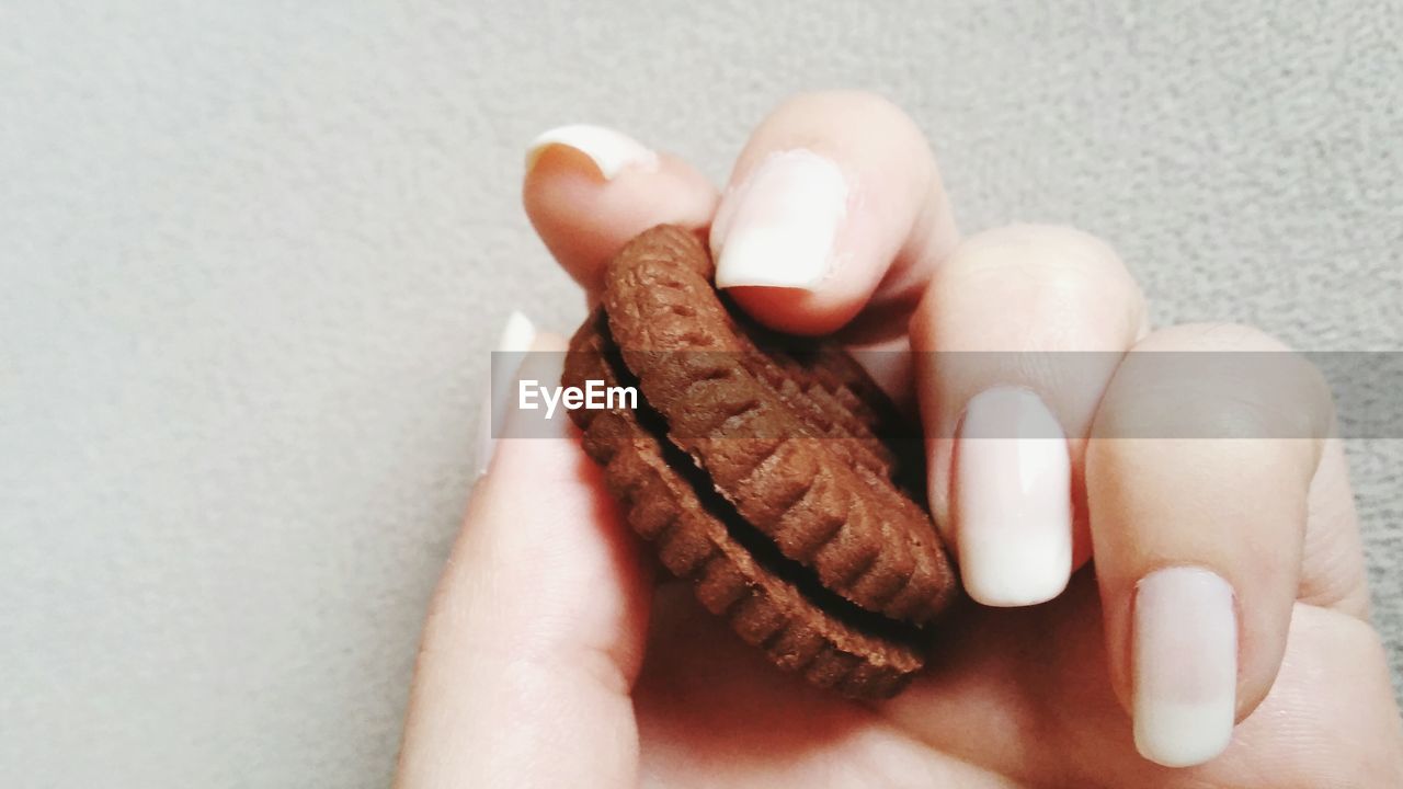 Close-up of hand holding biscuit