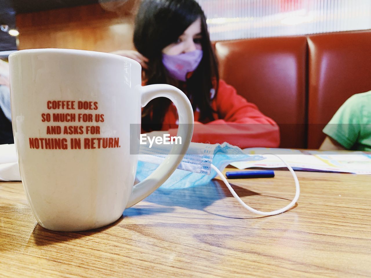 WOMAN WITH COFFEE CUP AND LAPTOP