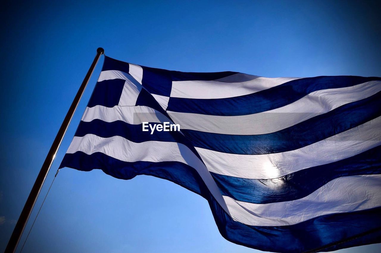 Low angle view of greek flag against clear sky