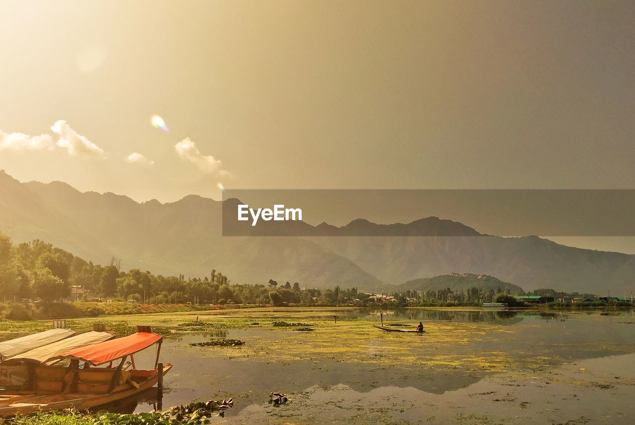 Dal lake with shikara and mountains in backdrop