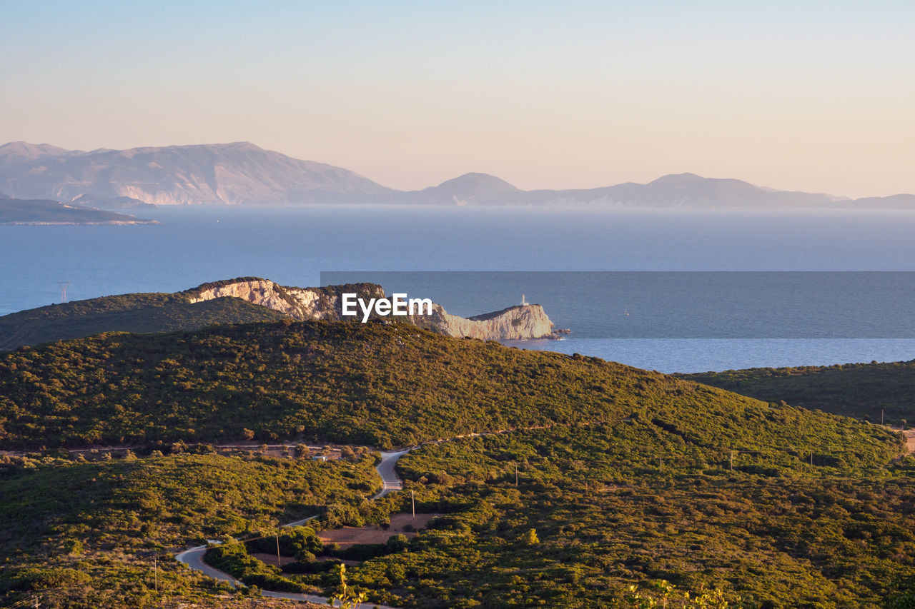 Scenic view of sea and mountains against sky