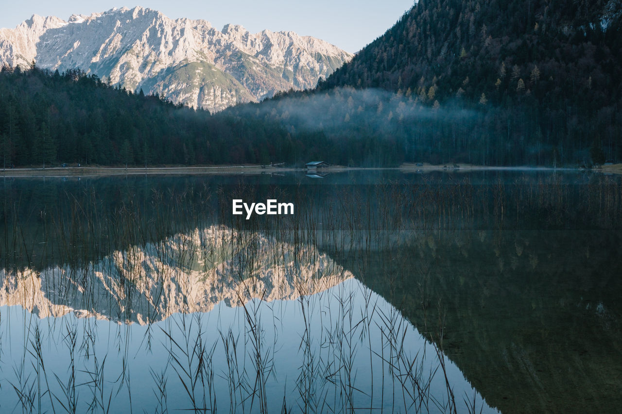 Scenic view of lake and mountains against sky