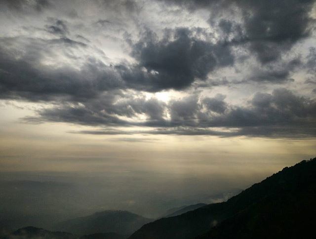 SCENIC VIEW OF MOUNTAINS AGAINST CLOUDY SKY