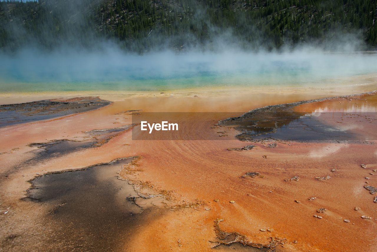 Geyser emitting smoke at yellowstone national park