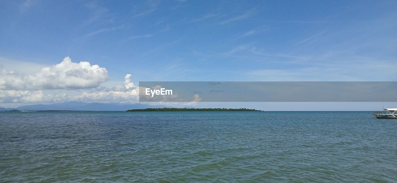 water, sea, sky, horizon, cloud, scenics - nature, shore, beauty in nature, travel, nautical vessel, blue, nature, transportation, ocean, vehicle, land, travel destinations, body of water, tranquility, mode of transportation, coast, bay, day, no people, tranquil scene, beach, environment, holiday, ship, vacation, tourism, trip, outdoors, sailing, island, idyllic, horizon over water, tropical climate, landscape, seascape, lagoon, wave, sailboat, motion