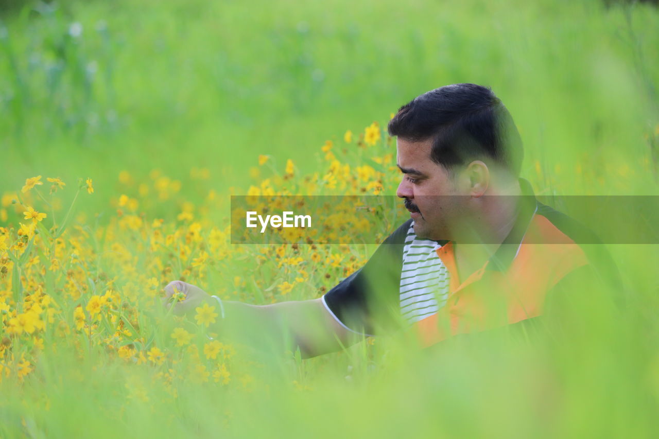 Man looking at flowers in farm