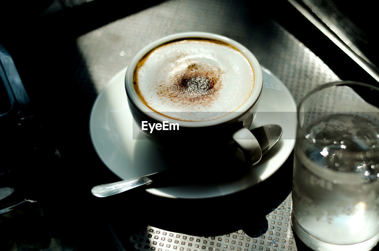 HIGH ANGLE VIEW OF COFFEE ON TABLE AT CAFE