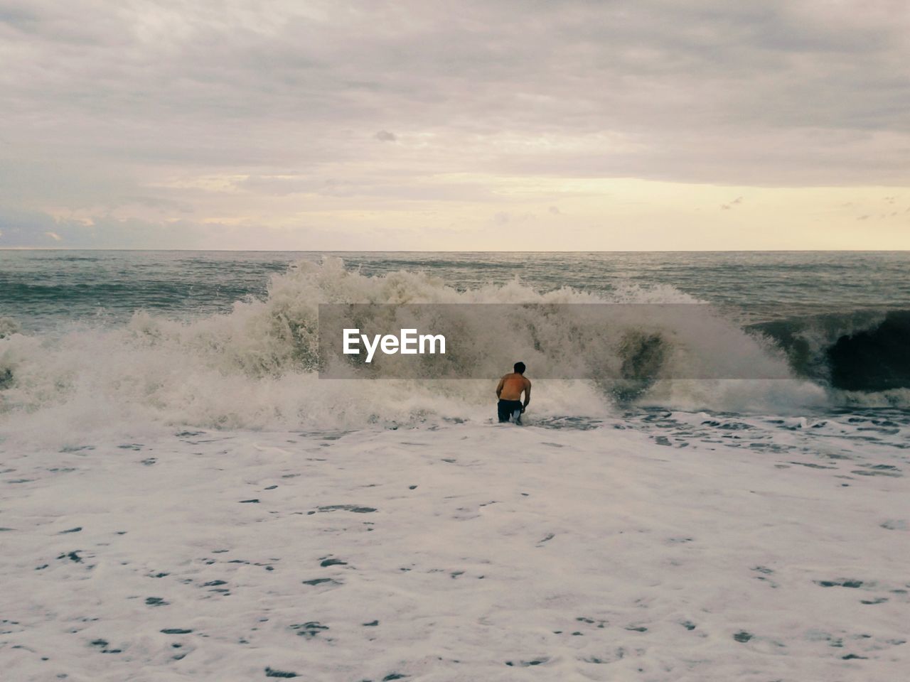 Rear view of a man swimming in the sea