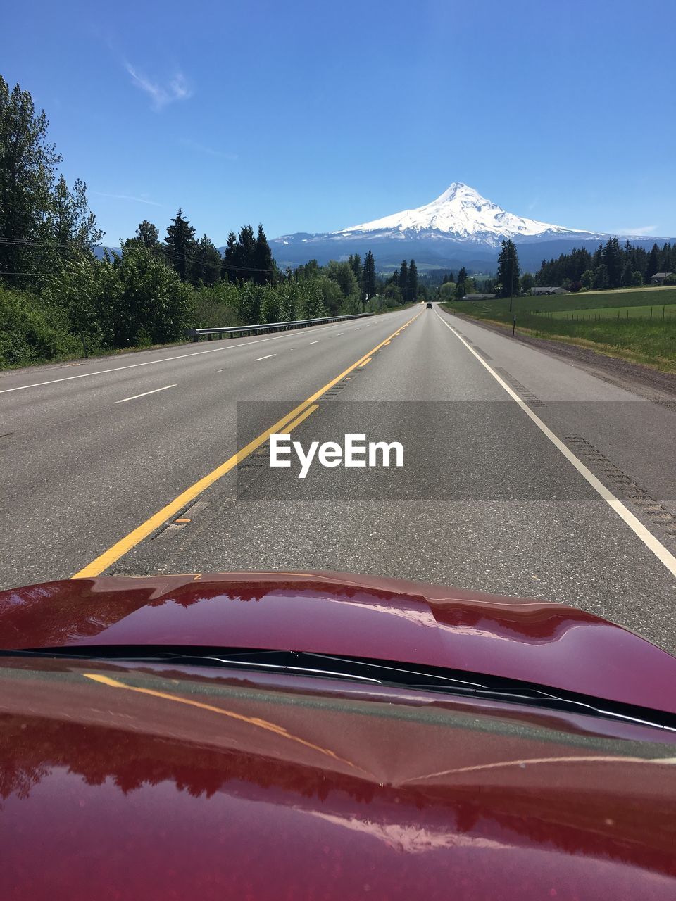 Road by mountains against sky