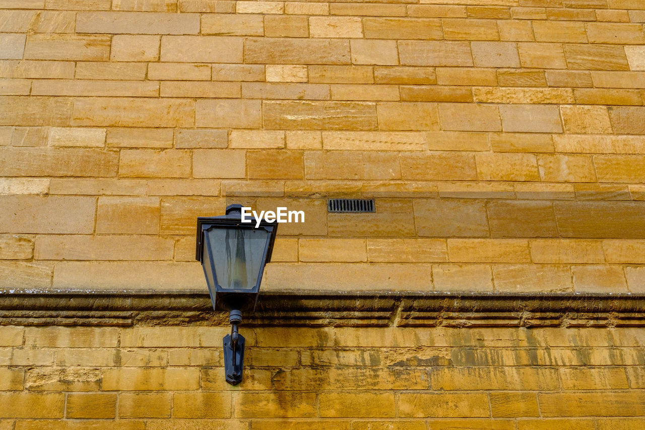 high angle view of security camera on brick wall