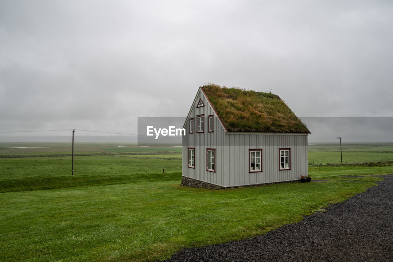 House on field against sky