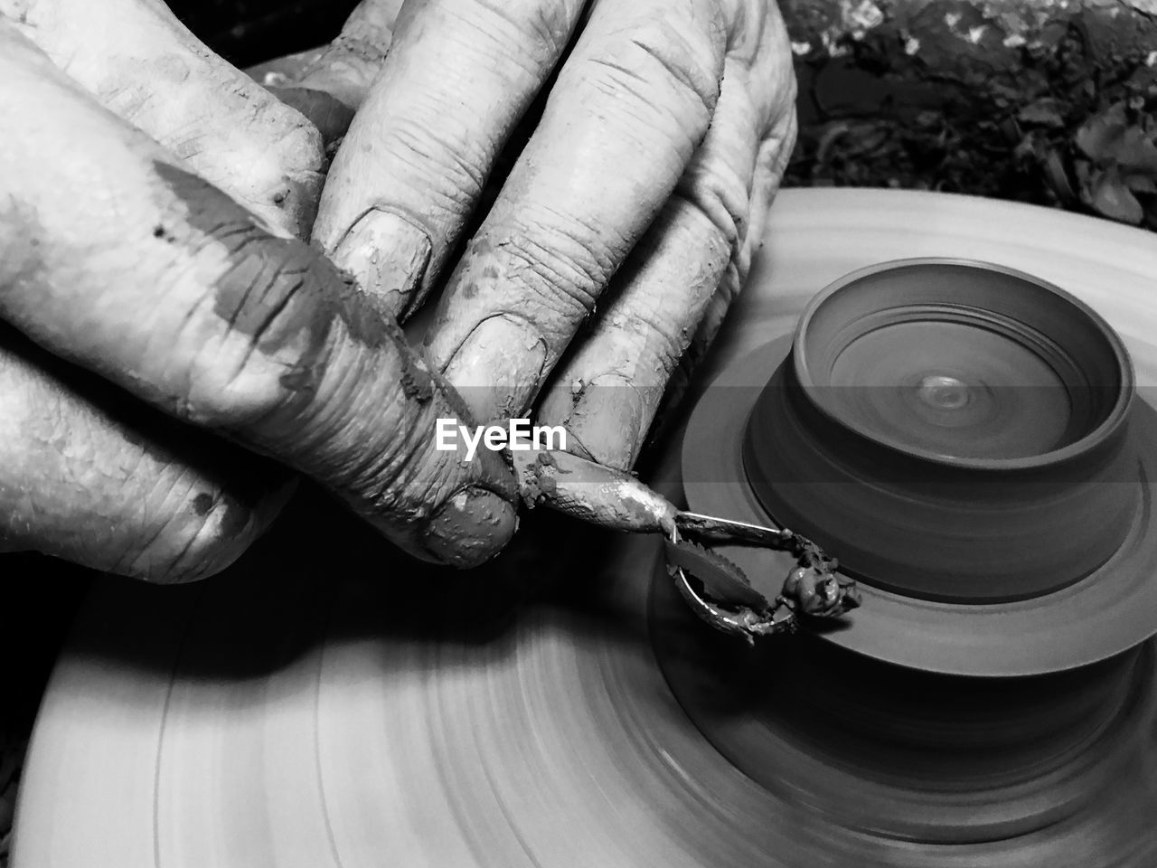 Cropped hands of person making pottery