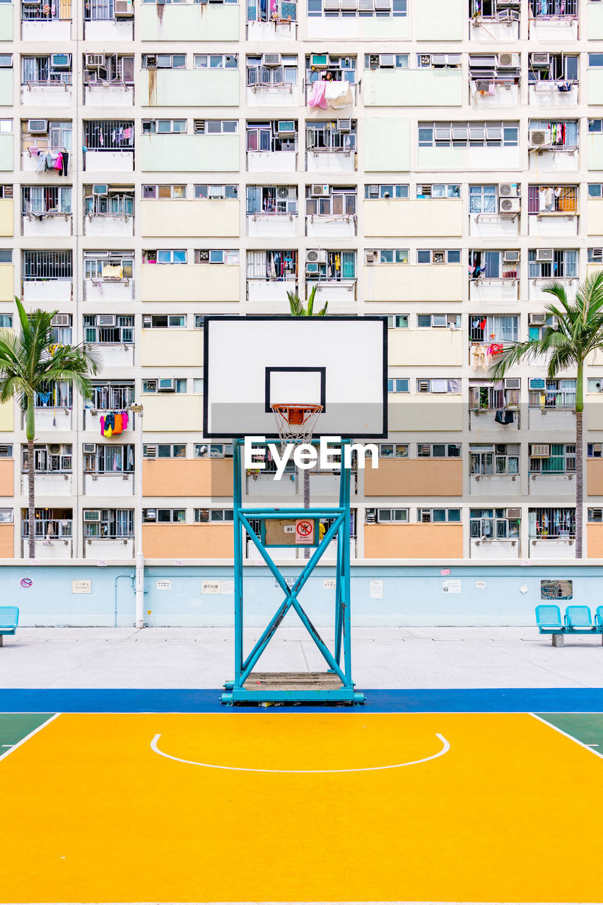 Basketball hoop against buildings in city