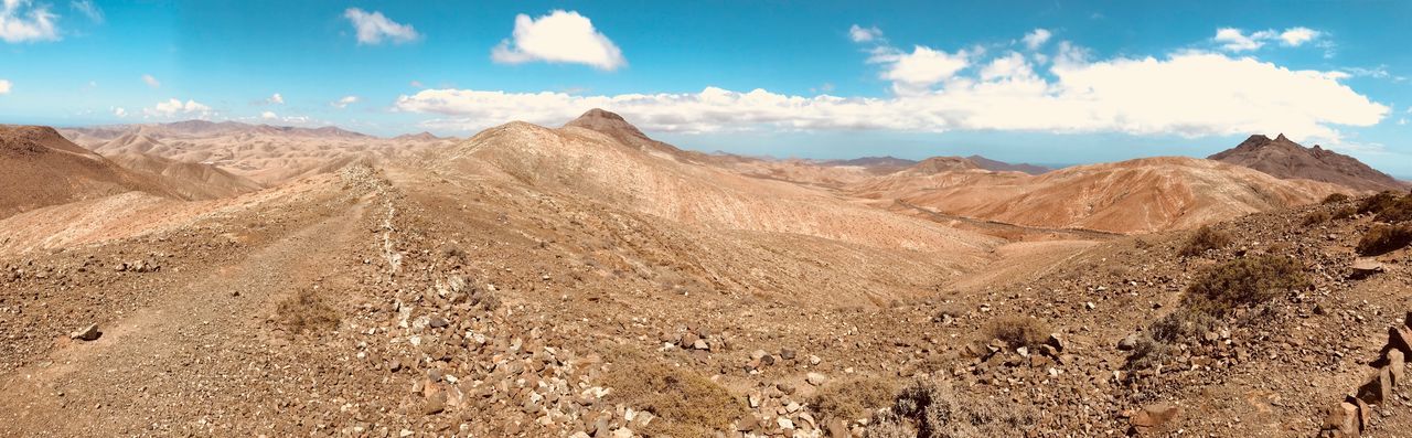 Panoramic view of arid landscape against sky