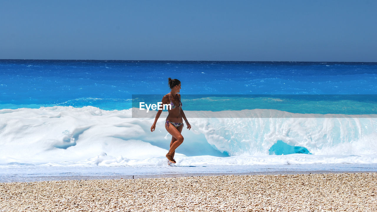 FULL LENGTH OF BOY ON BEACH