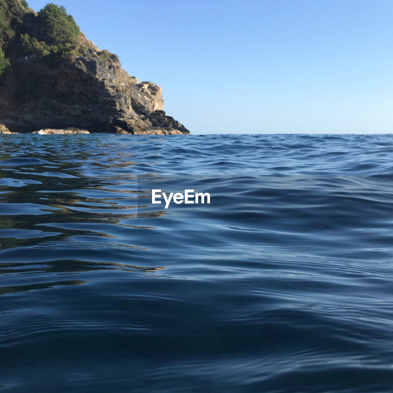 Scenic view of sea against clear blue sky