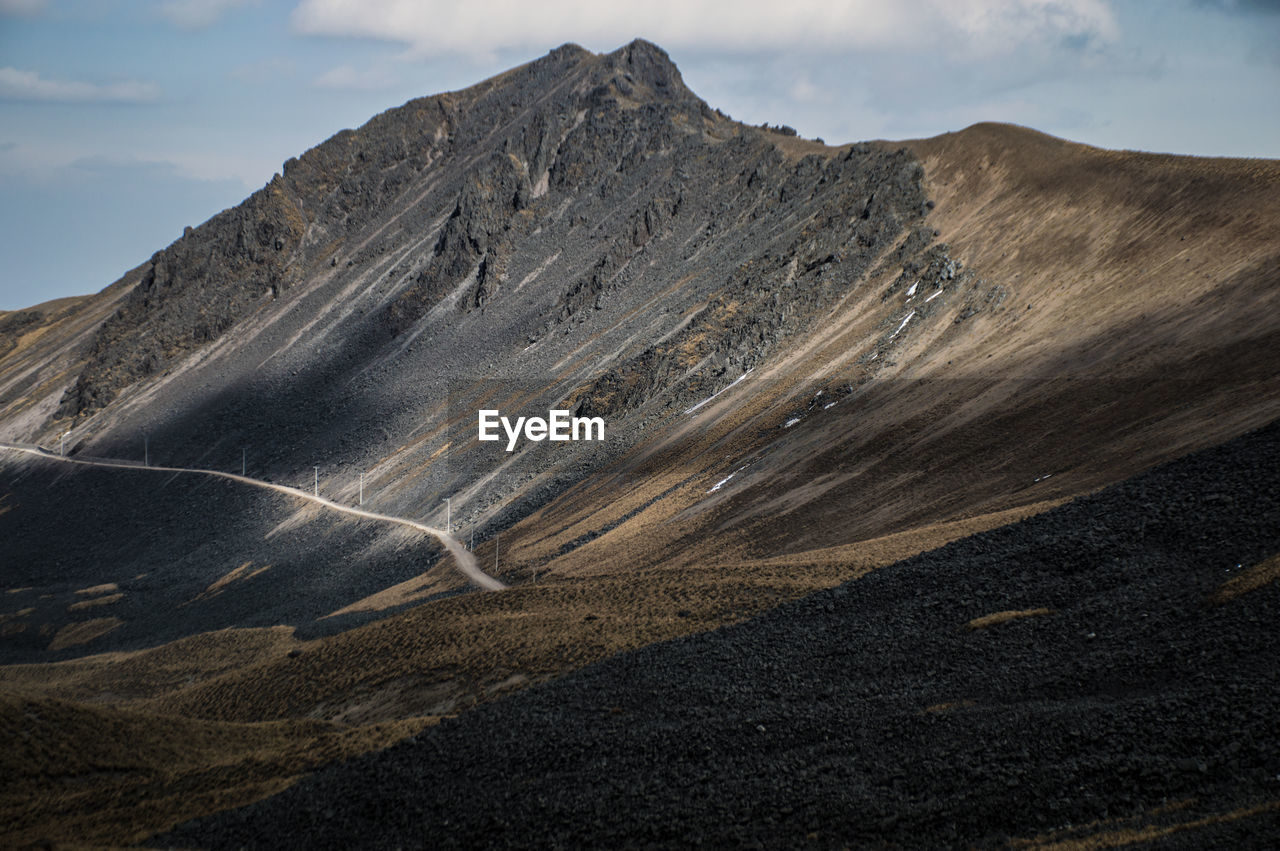 Scenic view of mountain road against sky