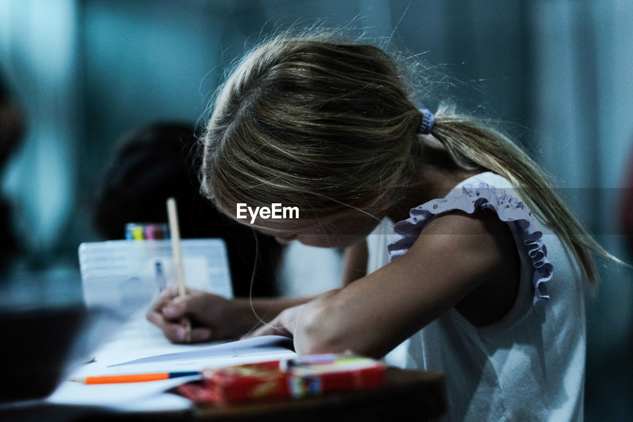 Portrait of little girl studying