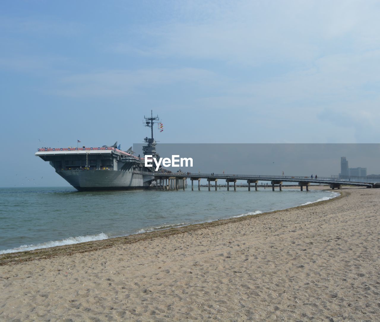 PIER ON BEACH AGAINST SKY