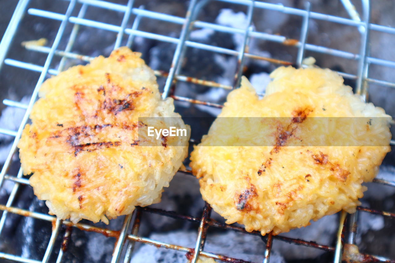 CLOSE-UP OF MEAT ON GRILL