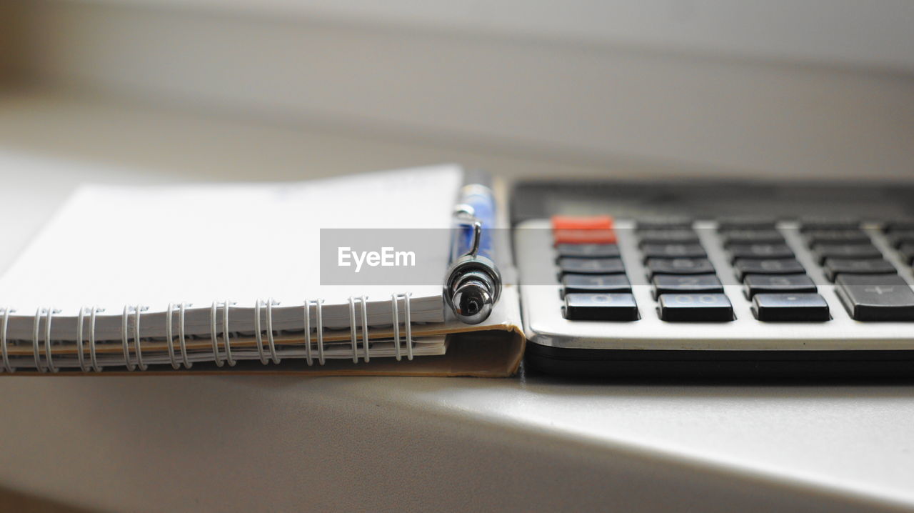 High angle view of calculator and book on table