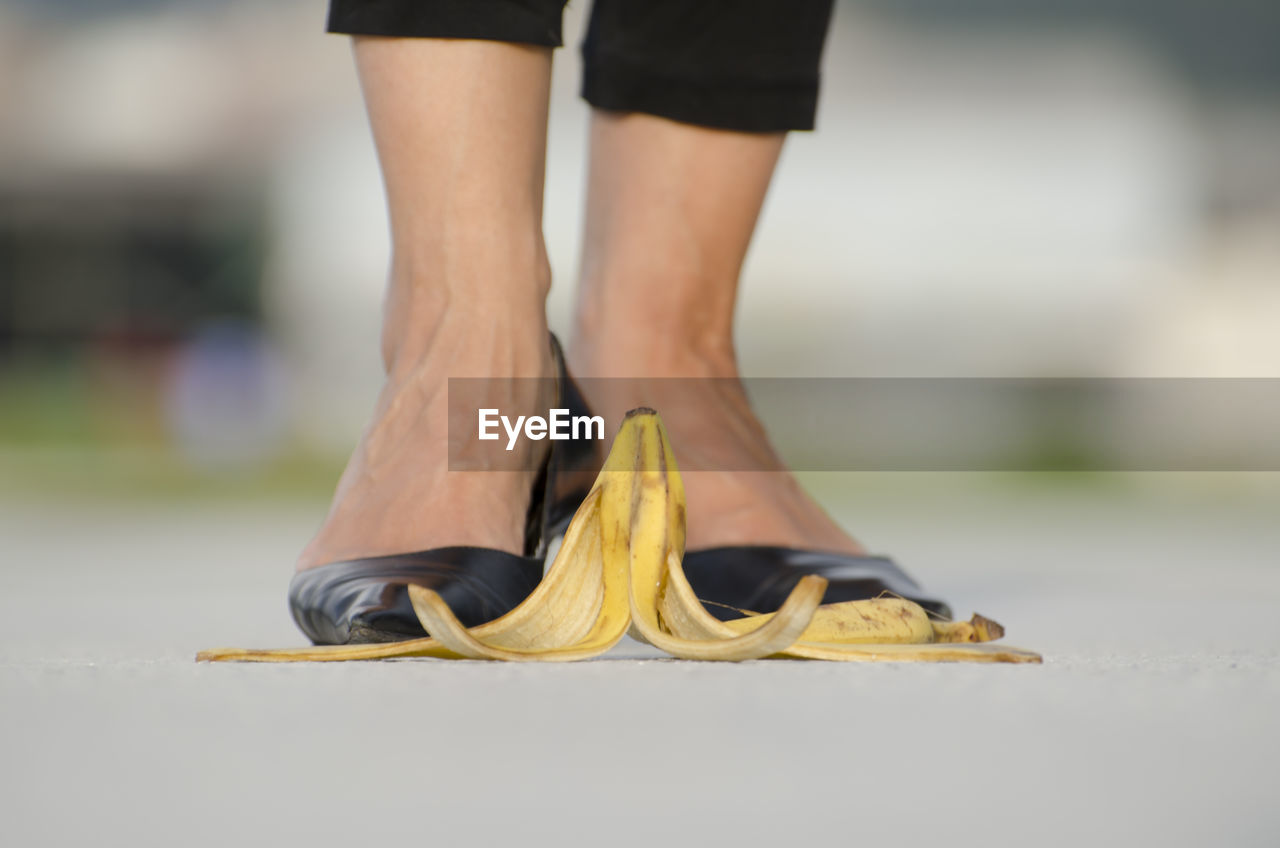 Woman with high heels standing in front of banana peel