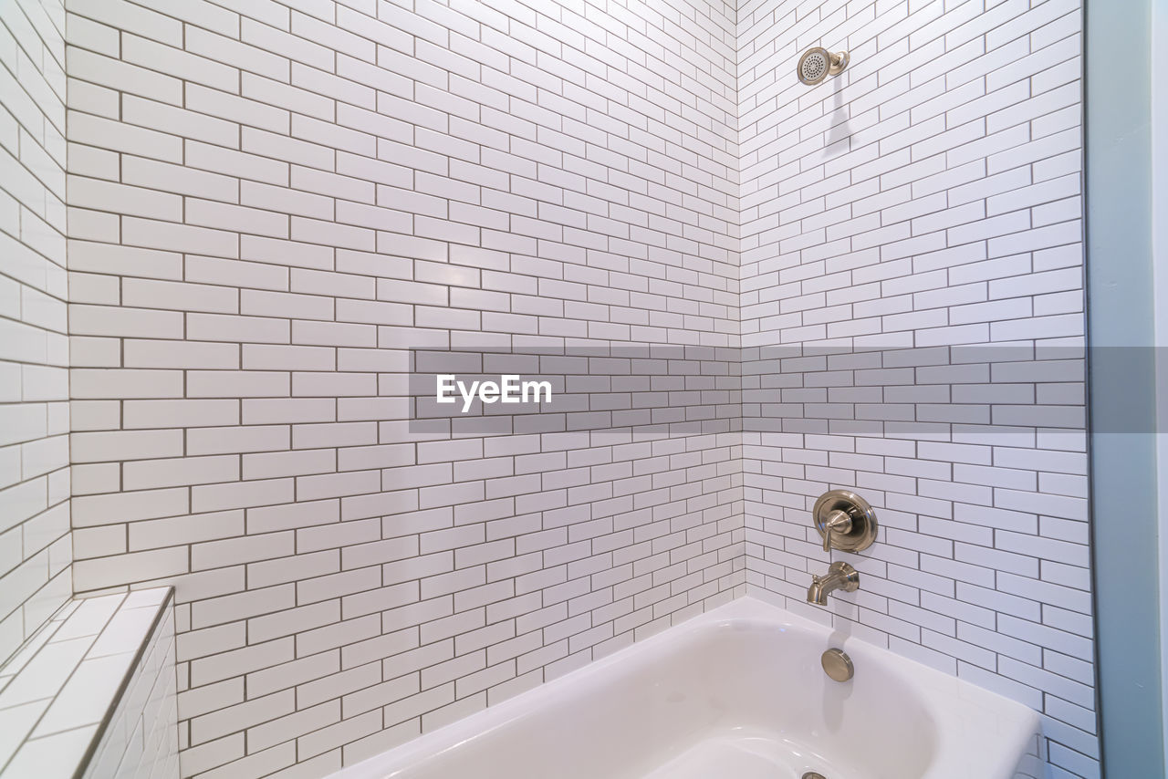 VIEW OF WHITE WALL THROUGH BATHROOM