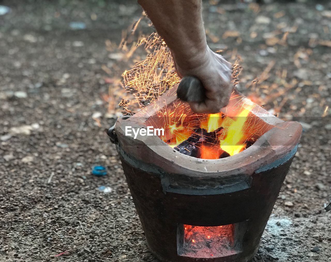 Blacksmith forging metal in burning coal