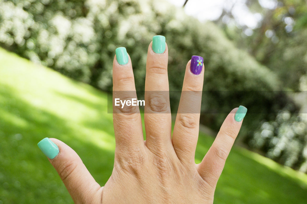 green, hand, finger, nail, grass, one person, focus on foreground, close-up, plant, nail polish, fingernail, manicure, adult, nature, day, women, leisure activity, lifestyles, outdoors, personal perspective, ring